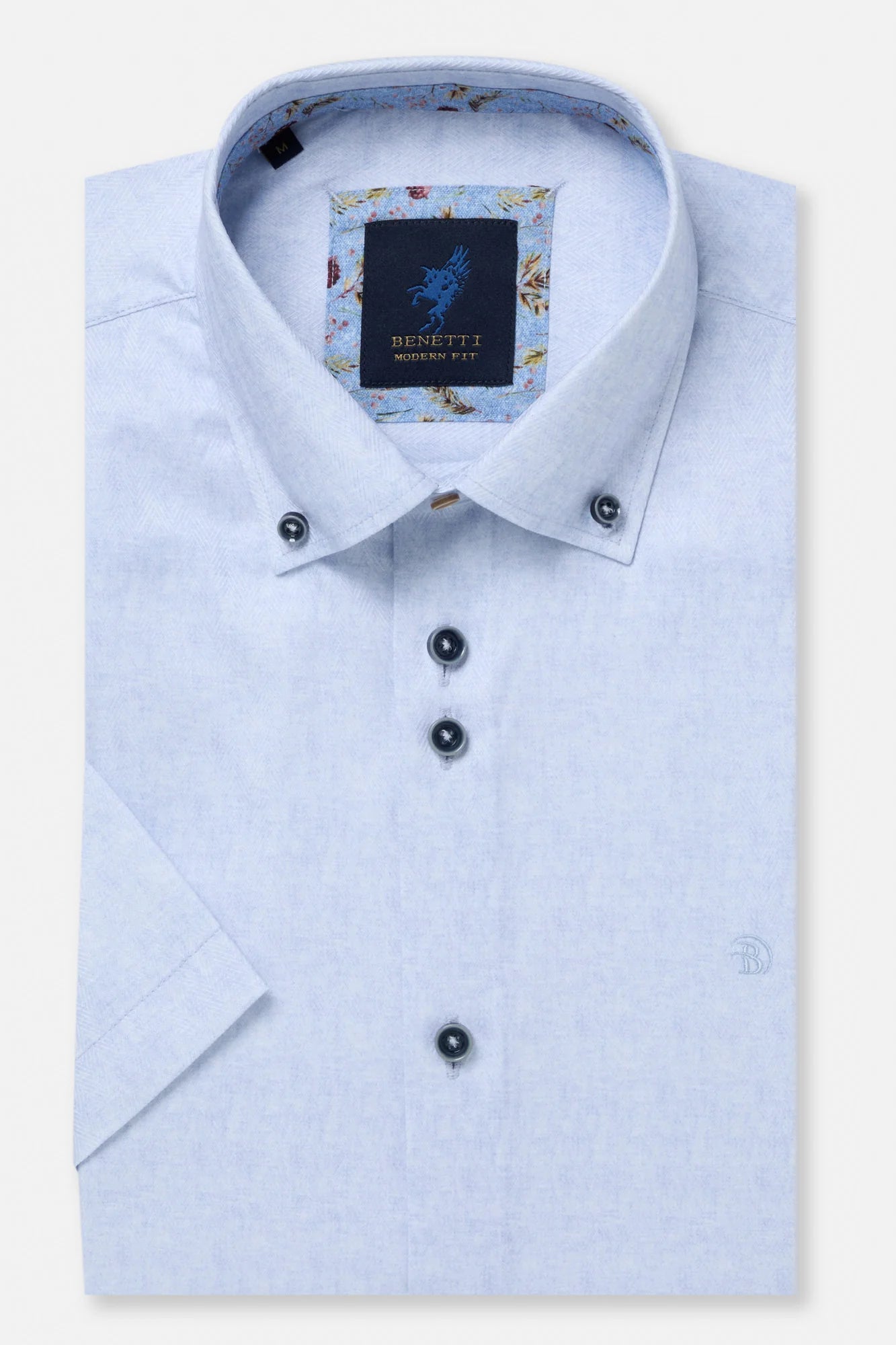 Light blue dress shirt with floral pattern on collar and Benetti label on a white background