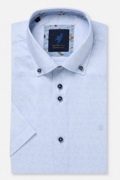 Light blue dress shirt with floral pattern on collar and Benetti label on a white background