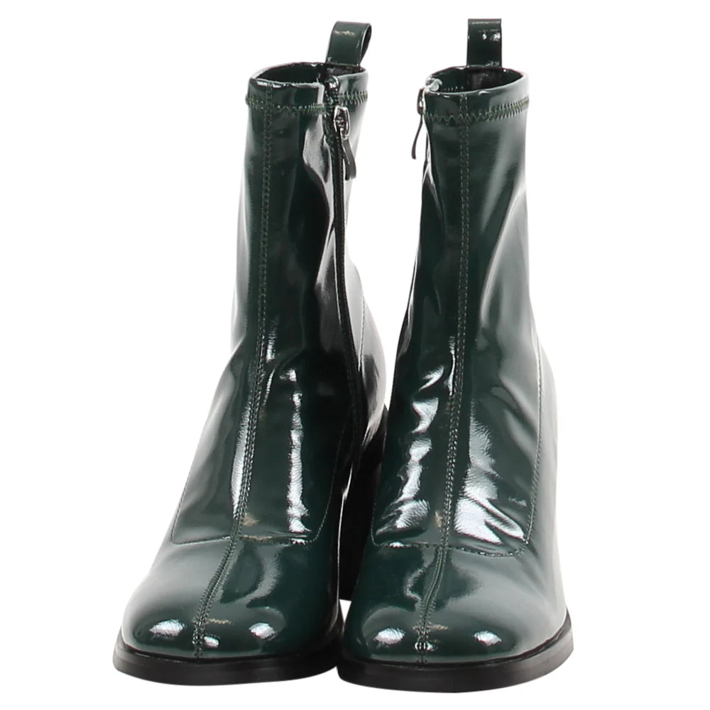Pair of green patent leather boots on a white background