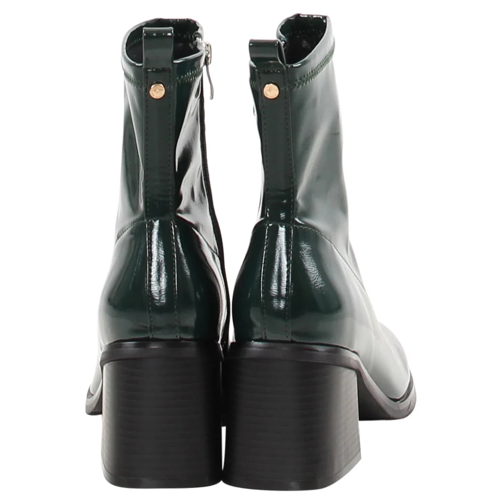 Pair of green patent leather boots on a white background