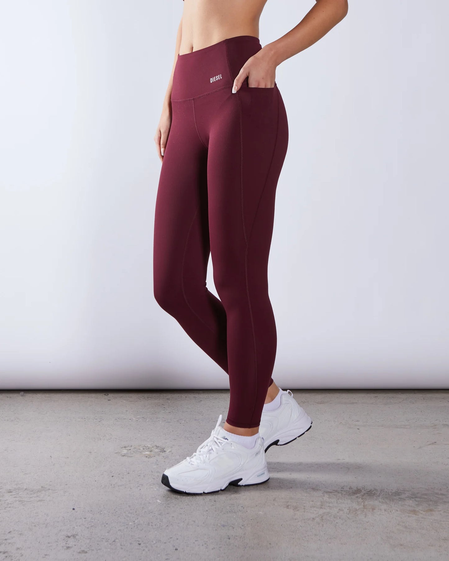 Maroon leggings worn by a person on a plain background