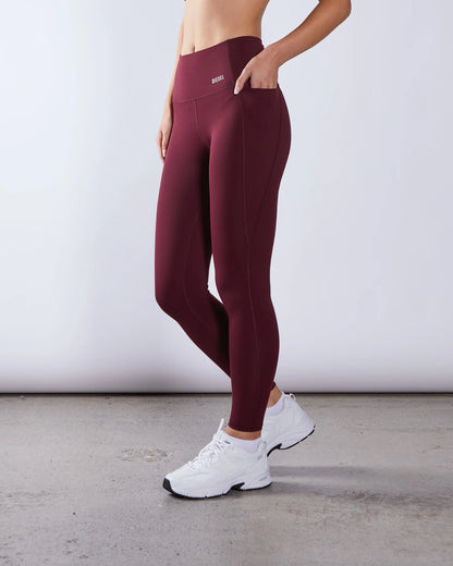 Maroon leggings worn by a person on a plain background