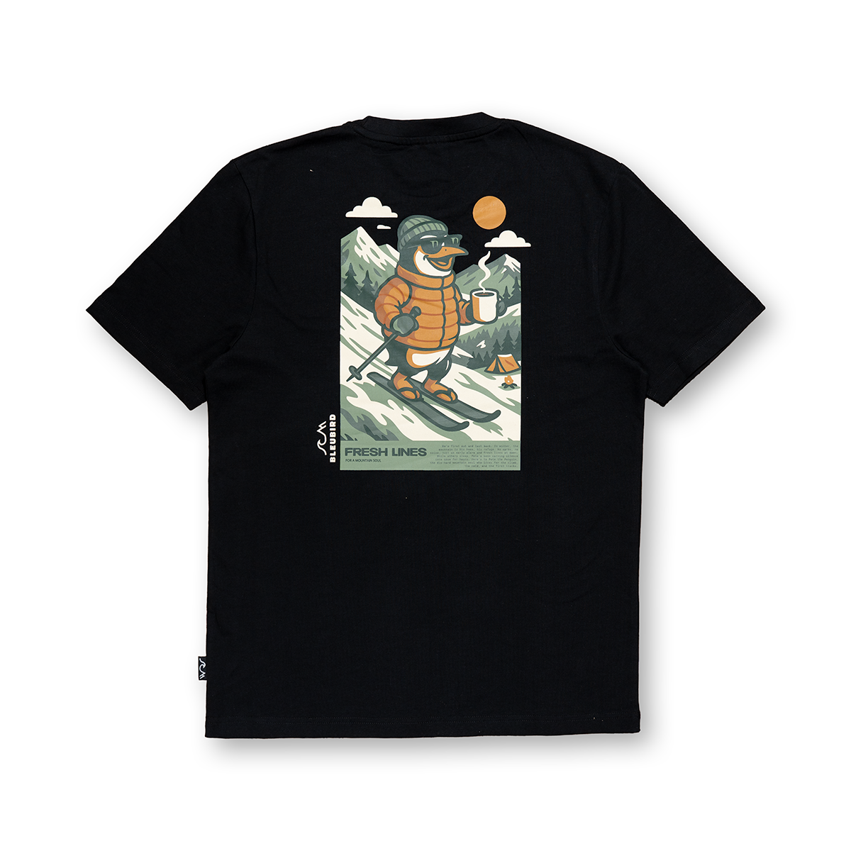 A black short-sleeve t-shirt shown from the back, featuring a large graphic print of a cartoon penguin wearing an orange puffer jacket and green beanie, skiing in a snowy mountain landscape with the text 'FRESHI LINES' and 'MADE IN DENMARK'.