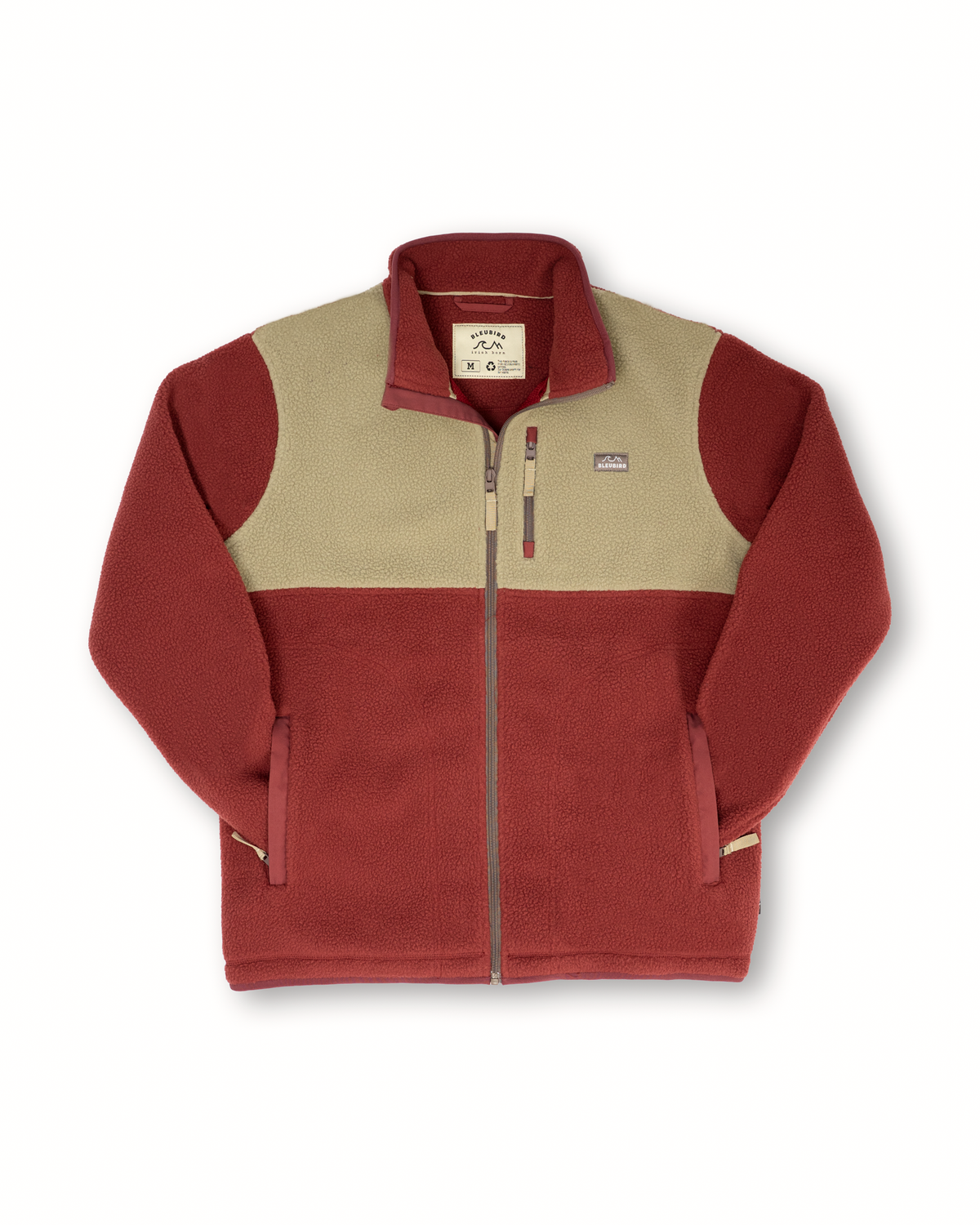 A fleece zip-up jacket with a color-blocked design, featuring a deep red lower body and sleeves, and a beige upper yoke and collar. It has a full front zipper, a vertical zip chest pocket, and a small rectangular logo patch on the left chest.