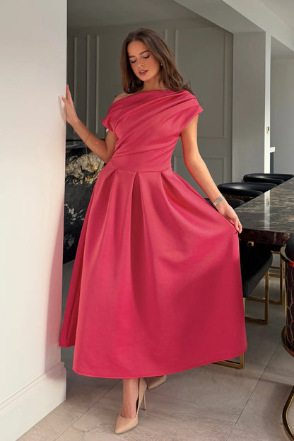 Woman in a pink dress standing in a modern interior setting