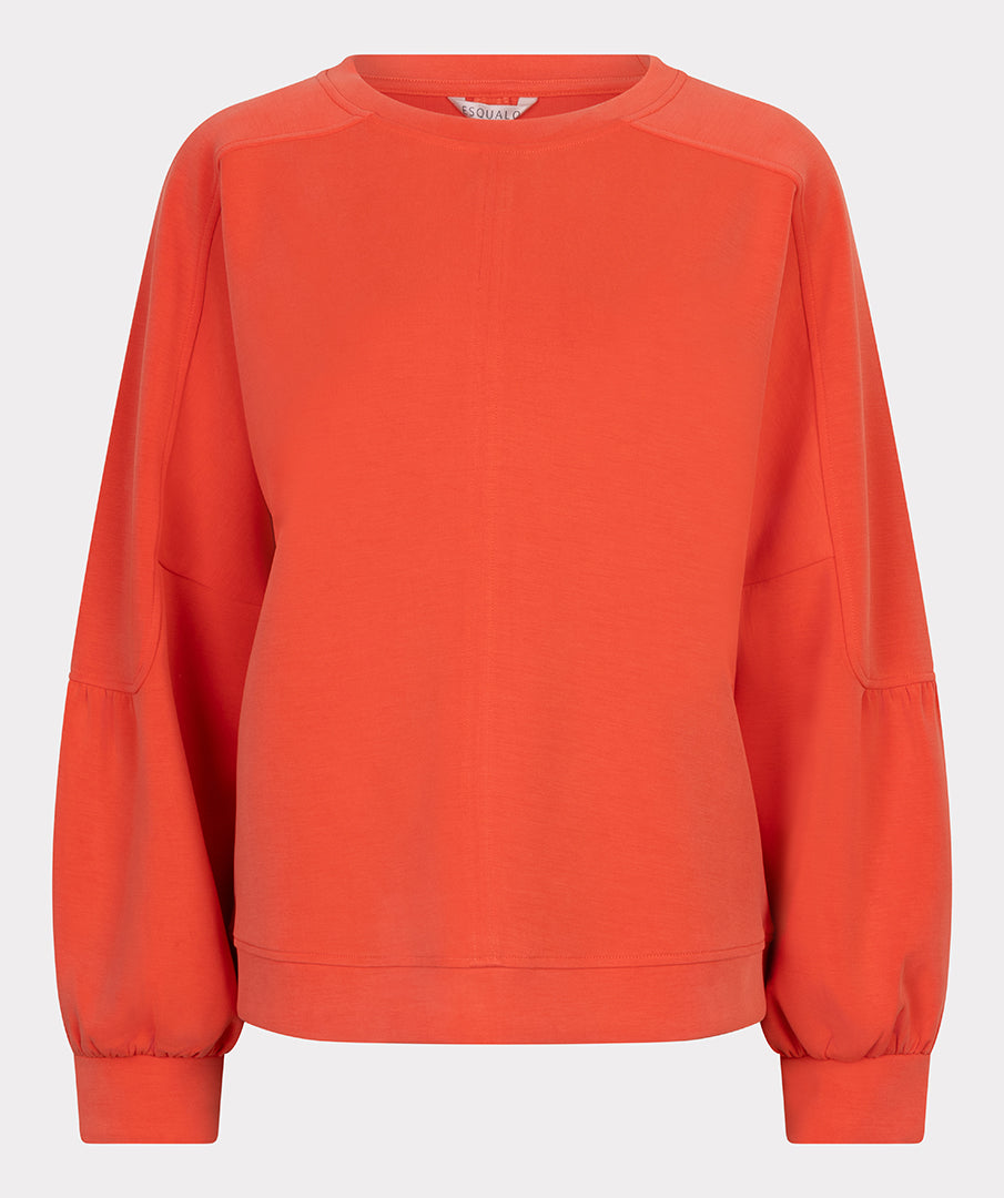 Orange sweatshirt on a light gray background