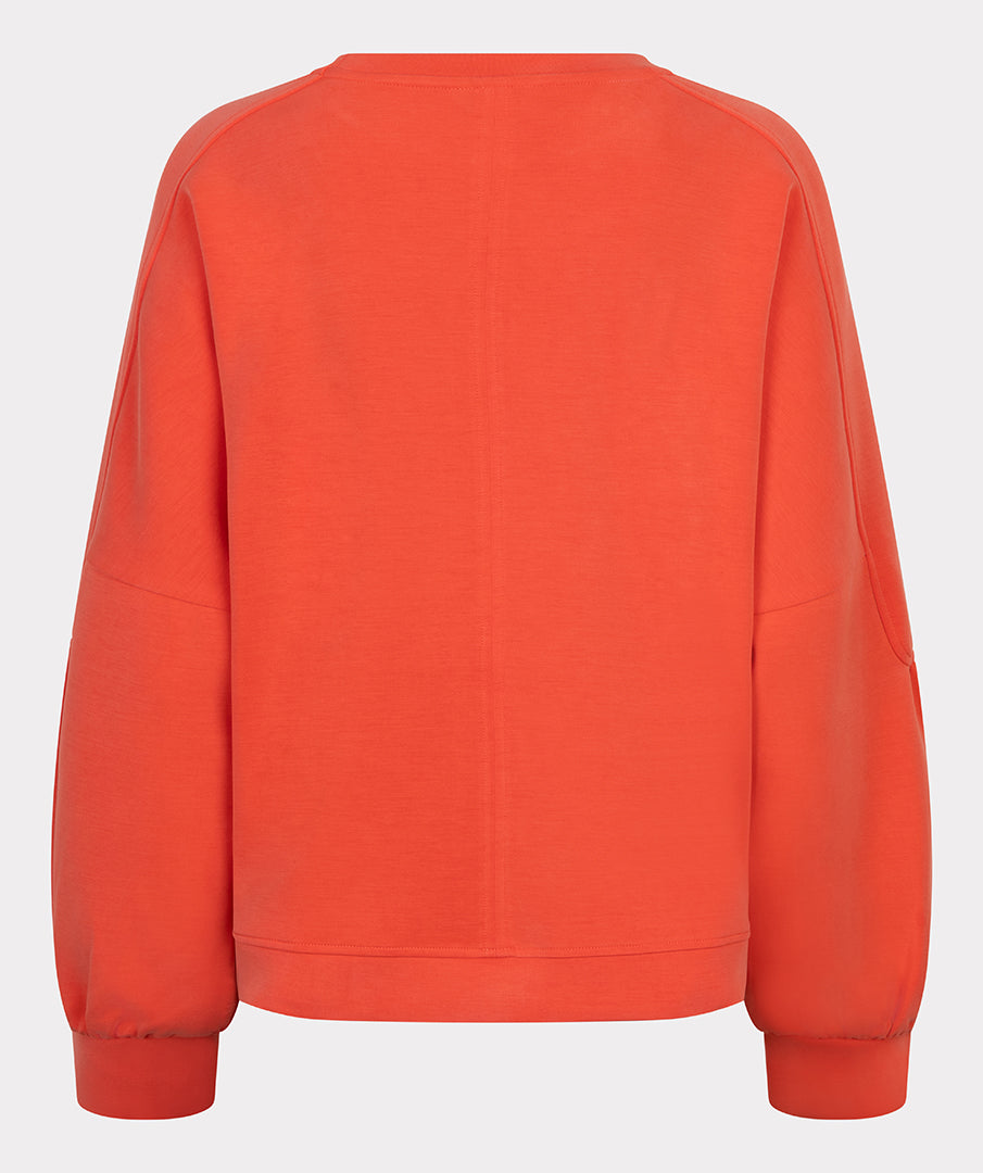 Orange sweatshirt on a light gray background