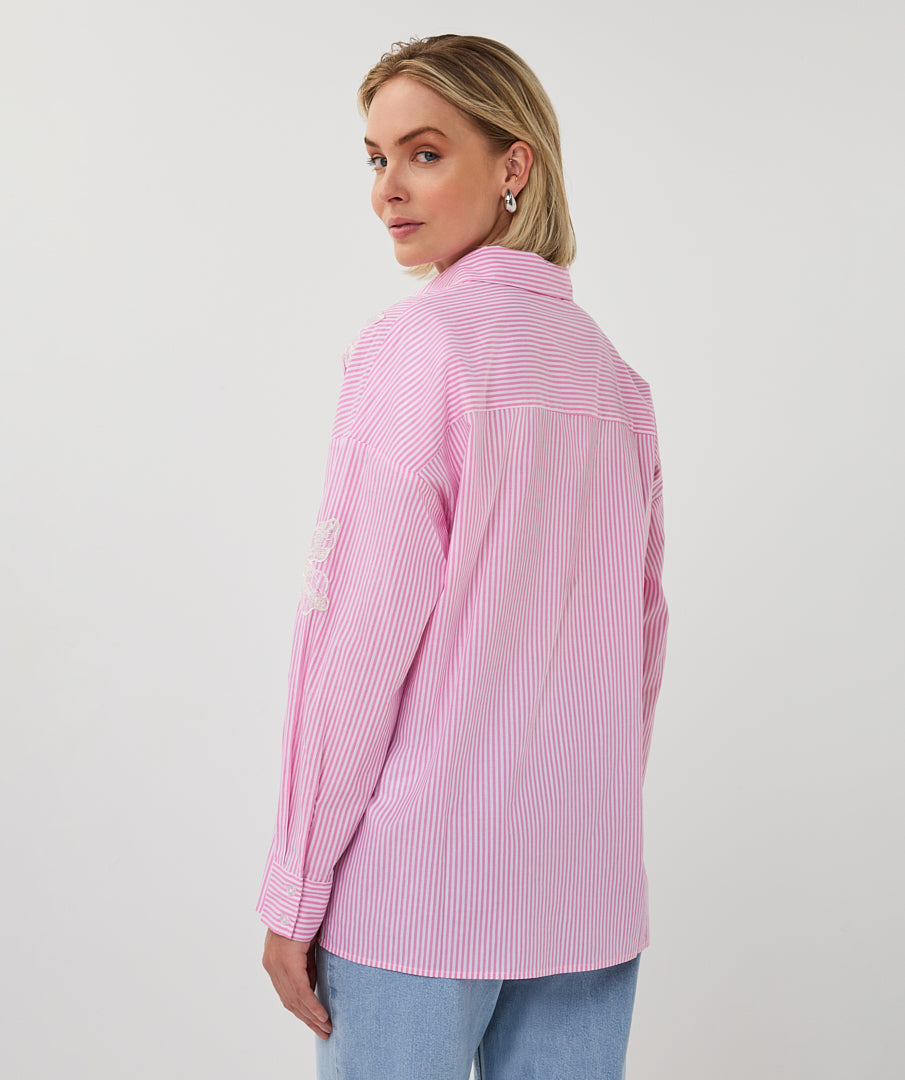 Woman wearing a pink striped shirt on a white background