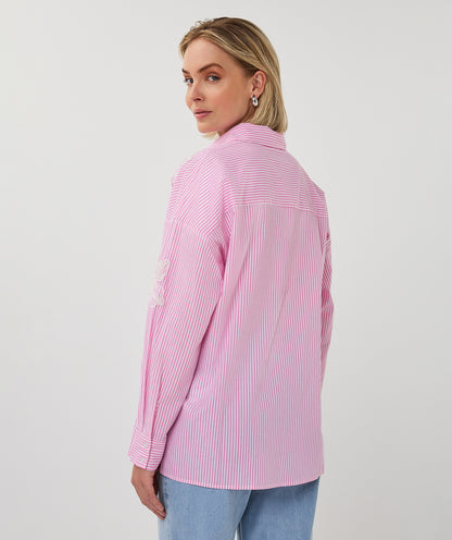 Woman wearing a pink striped shirt on a white background