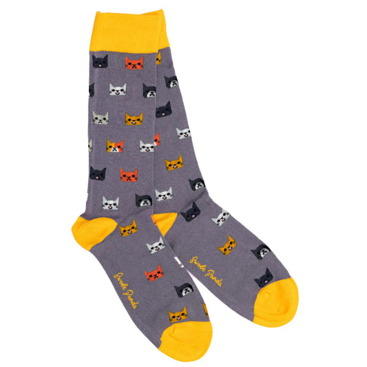 Gray socks with cat pattern and yellow accents on a white background