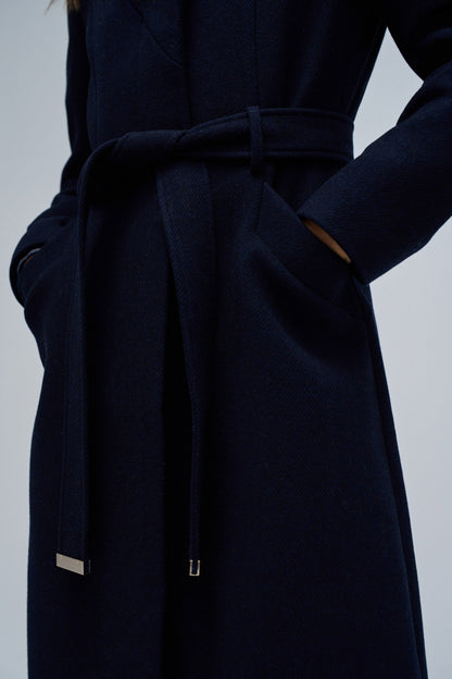 Navy blue coat with a belt on a light gray background