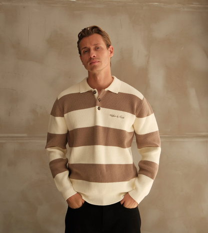 Man wearing a brown and white striped shirt against a textured beige wall