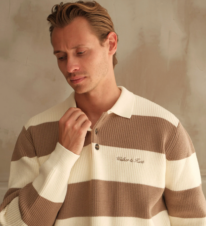 Man wearing a brown and beige striped sweater with 'Viktor & Rolf' branding.