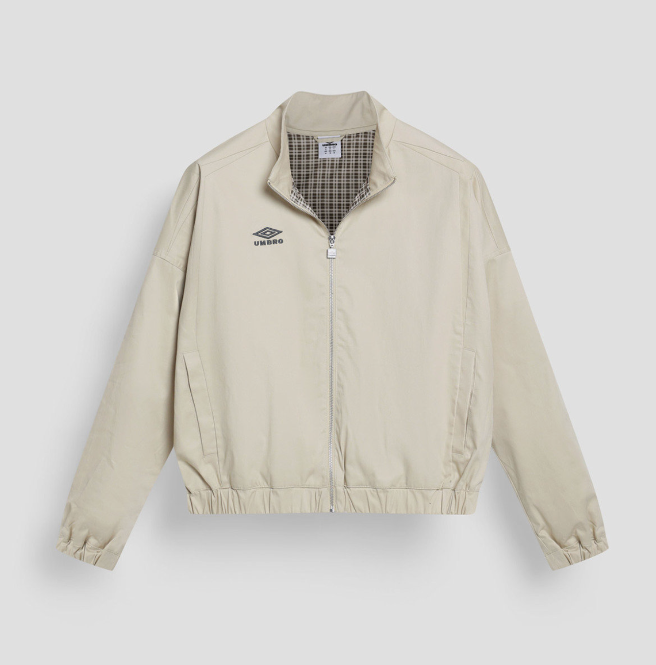 Beige jacket with plaid lining on a light gray background