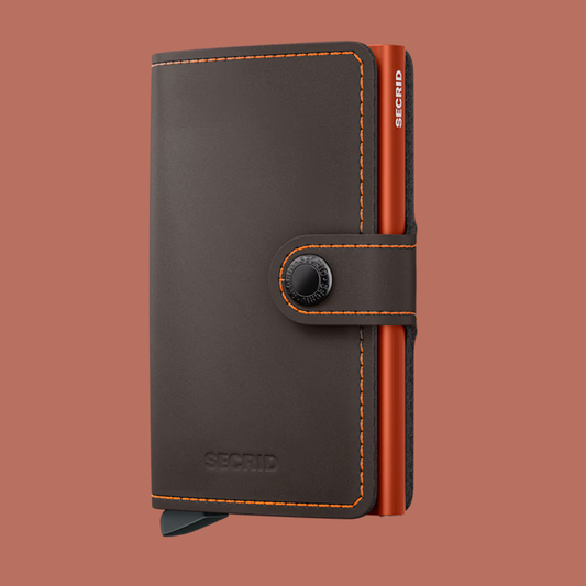 Black leather wallet with orange accents on a brown background