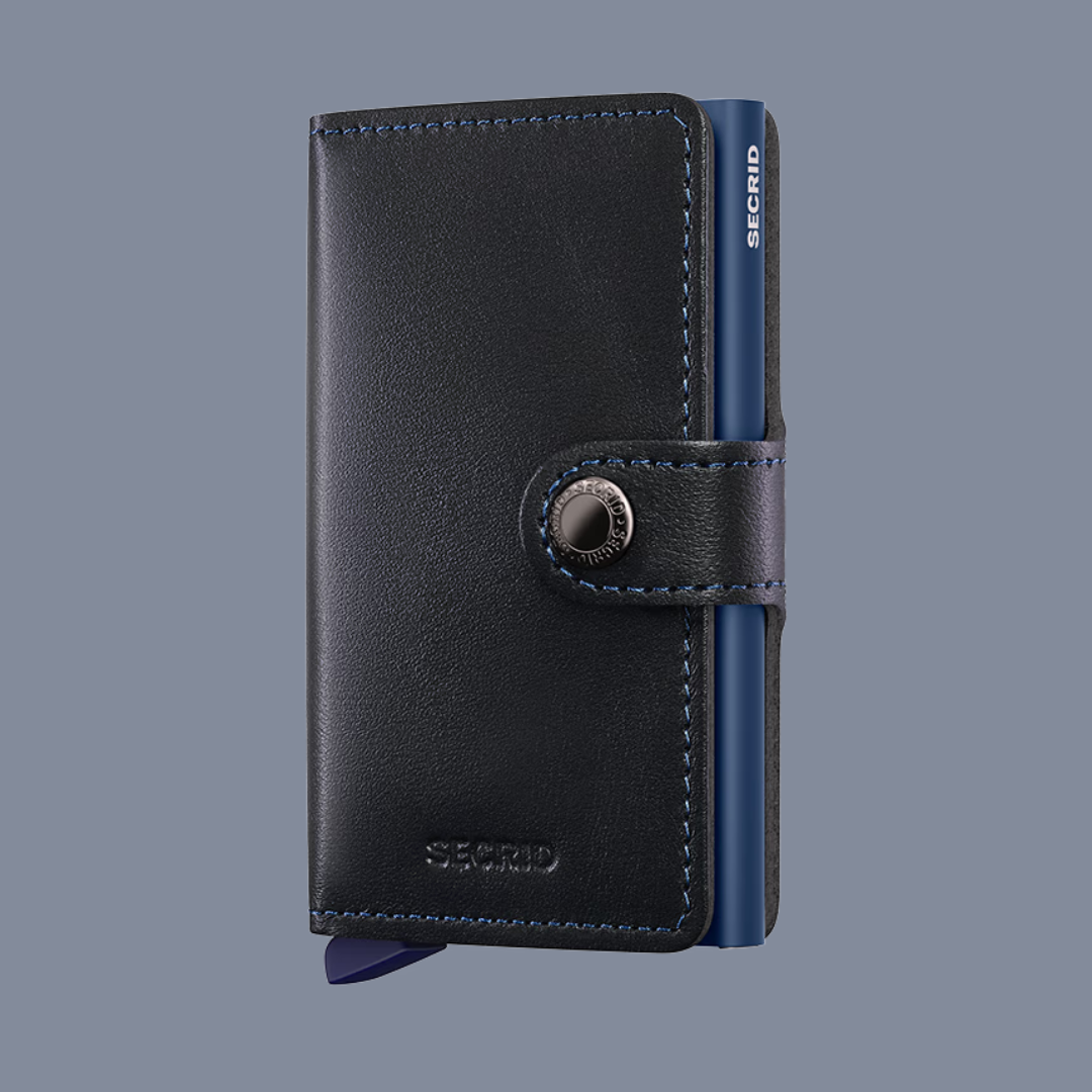 Black leather wallet with blue inner lining on a gray background