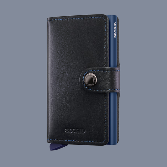Black leather wallet with blue inner lining on a gray background