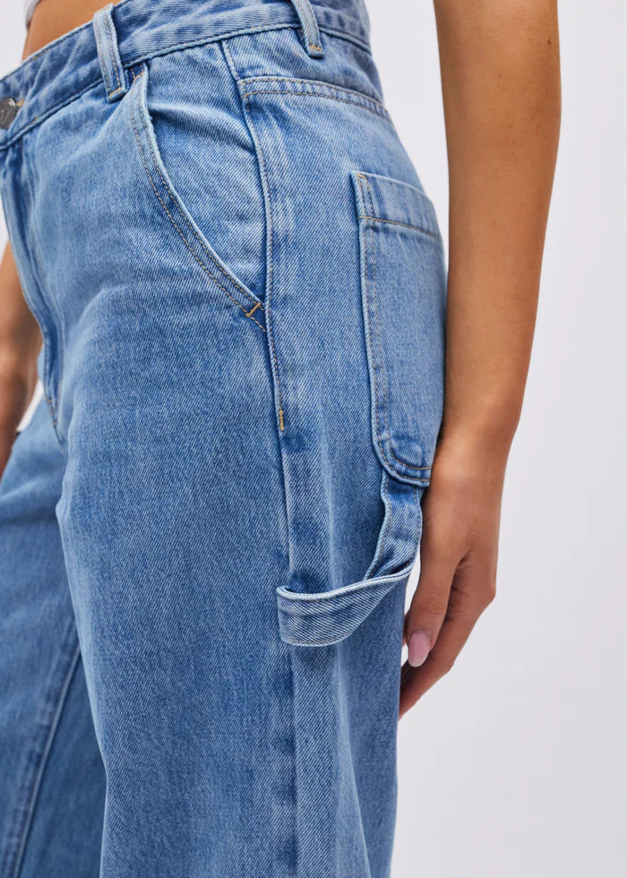 Close-up of blue jeans with a plain background