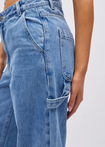 Close-up of blue jeans with a plain background