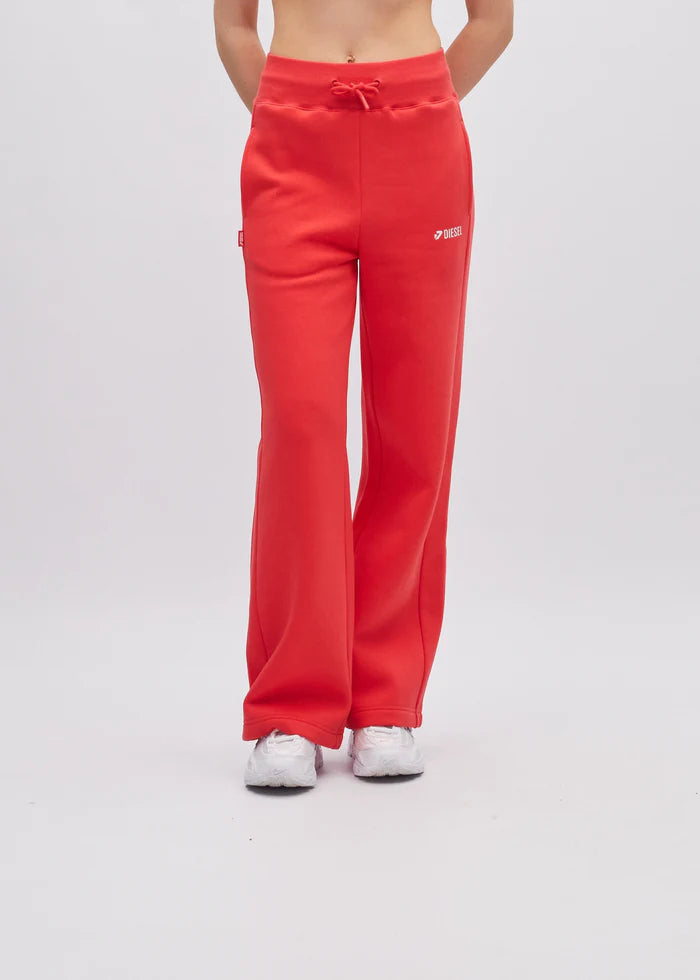 Red sweatpants worn by a person on a white background