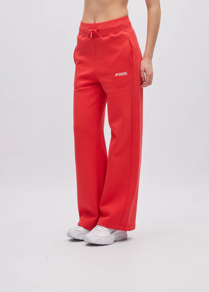 Red sweatpants with a brand logo worn by a person on a white background