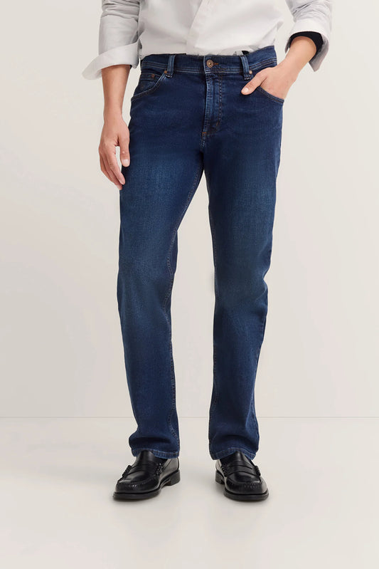 Person wearing dark blue jeans on a white background