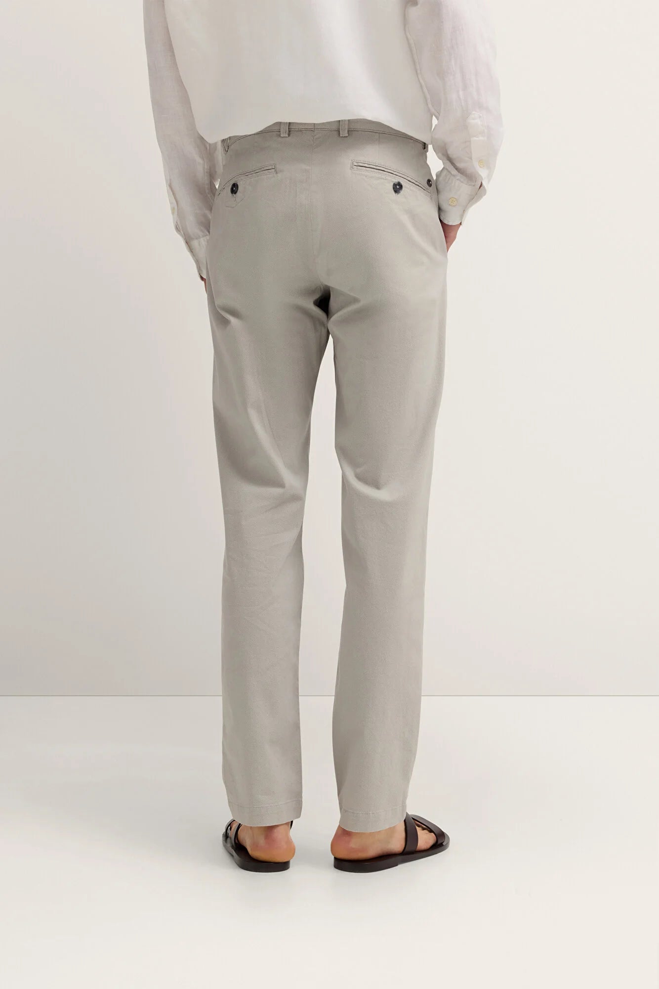 Light gray pants worn by a person on a white background