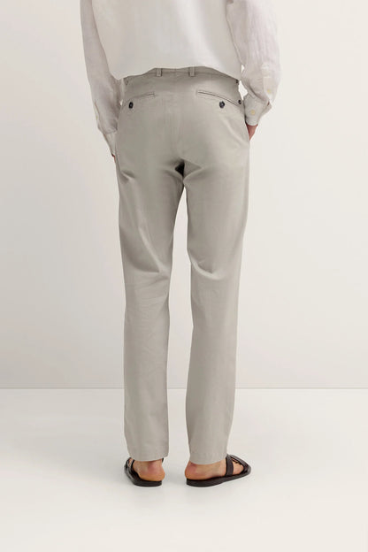 Light gray pants worn by a person on a white background