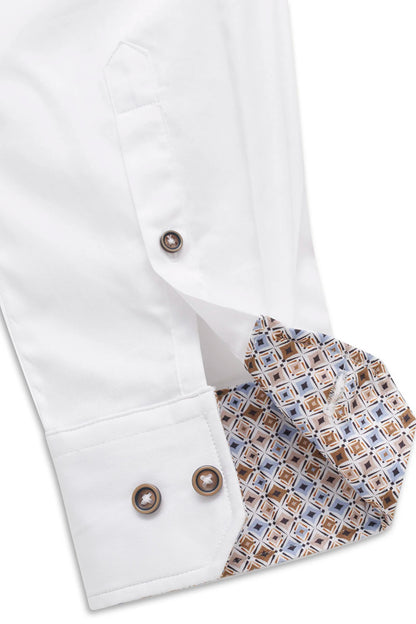 Close-up of a white dress shirt cuff with two buttoned cuffs and a patterned inner lining in beige, brown, and blue.