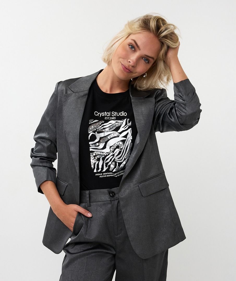 Person wearing a gray suit and black t-shirt with graphic design on a white background